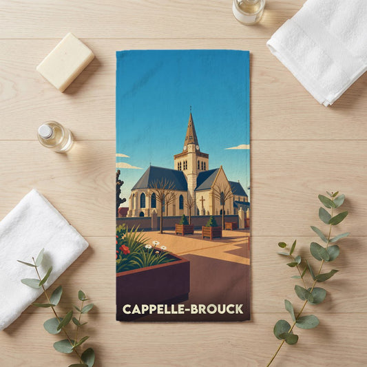 Serviette de bain souvenir de la ville de Cappelle-Brouck avec une illustration stylisée d'une église.