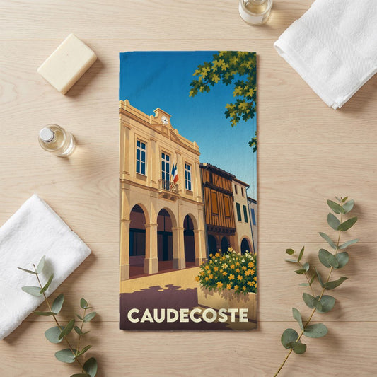 Serviette de bain souvenir de la ville de Caudecoste avec une illustration stylisée.
