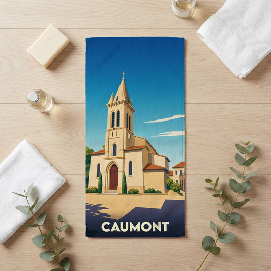 Serviette de bain souvenir de la ville de Caumont avec une illustration stylisée de son église.