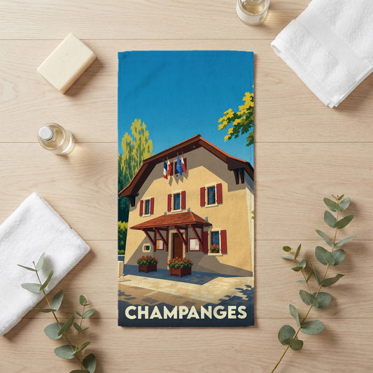 Serviette de bain souvenir de la ville de Champanges avec une illustration stylisée d'un bâtiment traditionnel.