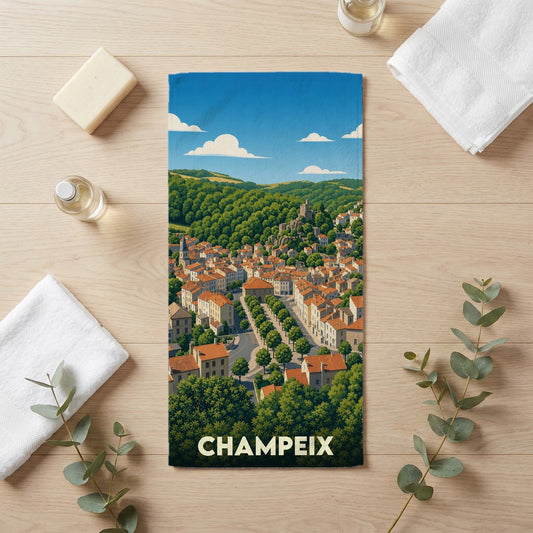 Serviette de bain souvenir de la ville de Champeix avec une illustration stylisée.