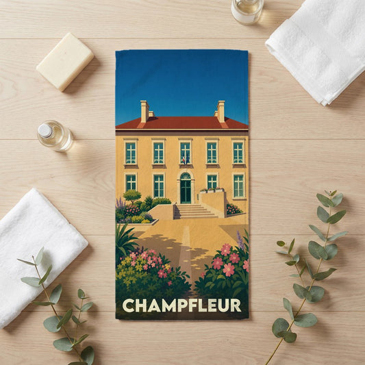 Serviette de bain souvenir de la ville de Champfleur avec une illustration stylisée d'un bâtiment classique.