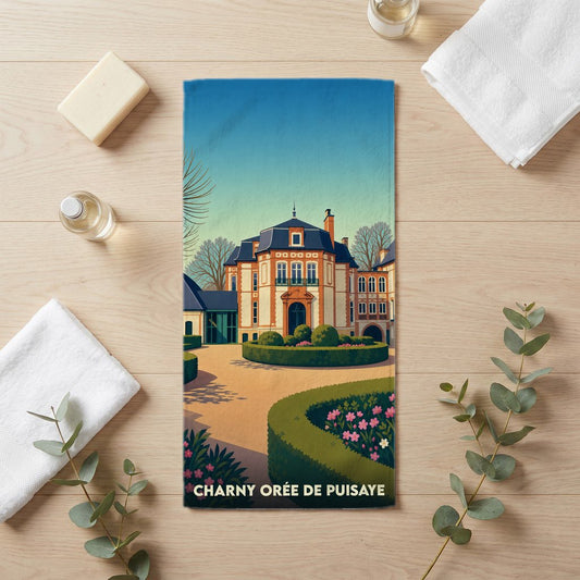 Serviette de bain souvenir de Charny Orée de Puisaye avec une illustration stylisée d'un château et de ses jardins.