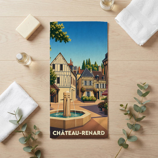 Serviette de bain souvenir de la ville de Château-Renard avec une illustration stylisée d'une place provençale.