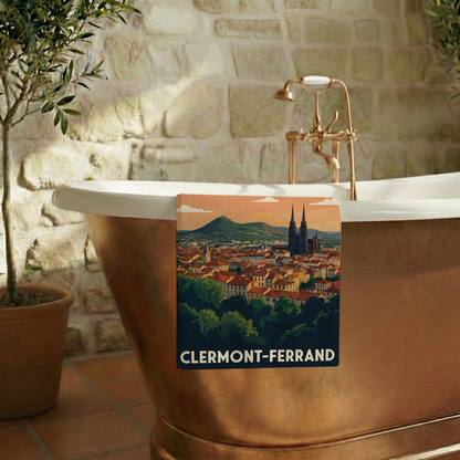 Serviette de bain souvenir de Clermont-Ferrand avec une illustration stylisée du panorama de la ville et du Puy de Dôme.