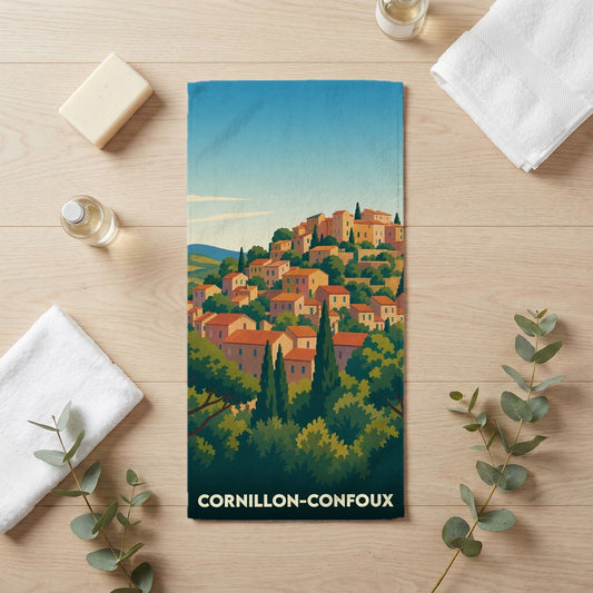 Serviette de bain souvenir de la ville de Cornillon-Confoux avec une illustration stylisée d'un village provençal.