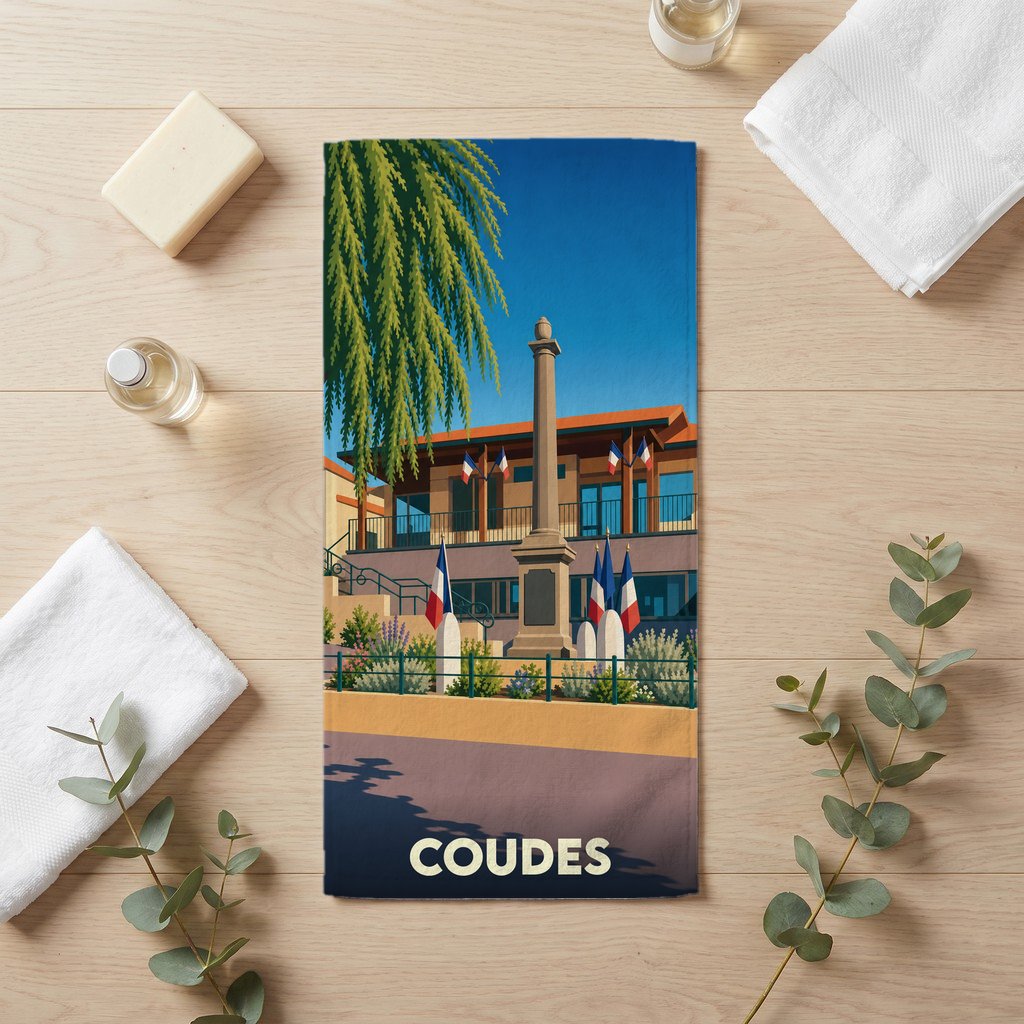 Serviette de bain souvenir de la ville de Coudes avec une illustration stylisée.