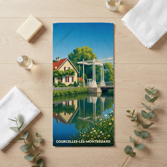 Serviette de bain souvenir de Courcelles-lès-Montbéliard avec une illustration stylisée d'un canal et de son pont levant.