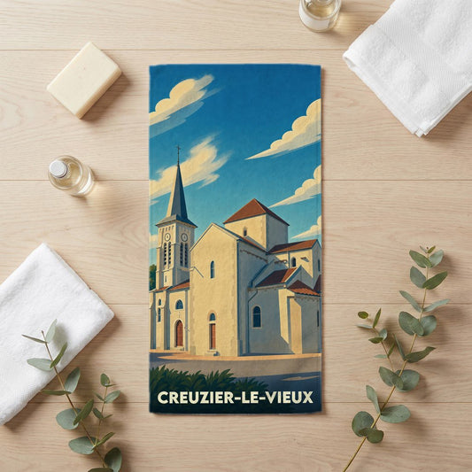 Serviette de bain souvenir de la ville de Creuzier-le-Vieux illustrée d'une église sous un ciel bleu.