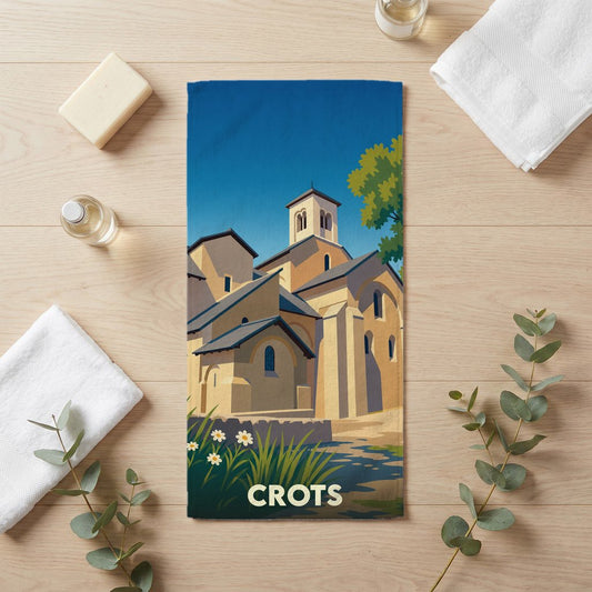 Serviette de bain souvenir de la ville de Crots avec une illustration stylisée de son patrimoine architectural.