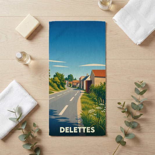 Serviette de bain souvenir de la ville de Delettes illustrant une route de campagne menant au village.