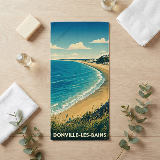 Serviette de bain souvenir de la ville de Donville-les-Bains avec une illustration balnéaire stylisée.