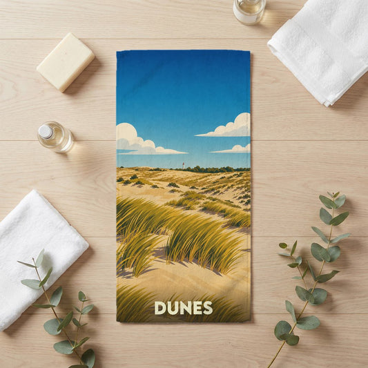 Serviette de bain souvenir de la ville de Dunes avec une illustration stylisée de paysage côtier.