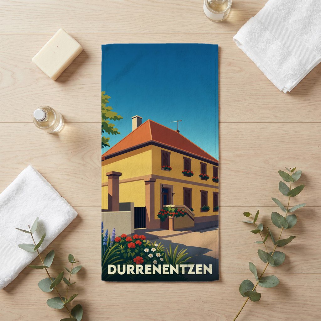 Serviette de bain souvenir de la ville de Durrenentzen avec une illustration stylisée d'une maison alsacienne.
