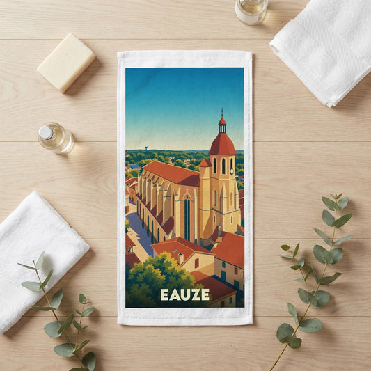 Serviette de bain souvenir de la ville de Eauze avec une illustration stylisée d'une église sous un ciel bleu.