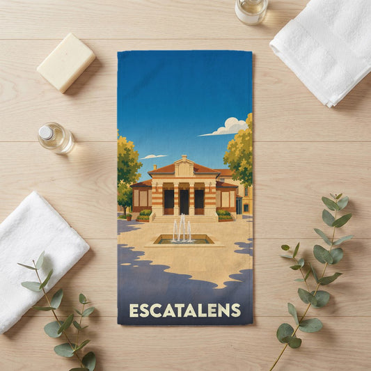Serviette de bain souvenir de la ville d'Escatalens avec une illustration stylisée d'un bâtiment historique et de sa fontaine.