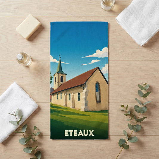 Serviette de bain souvenir de la ville d'Eteaux avec une illustration stylisée de son église.