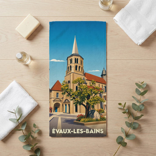 Serviette de bain souvenir de la ville d'Évaux-les-Bains avec une illustration stylisée de son église et de son centre historique.