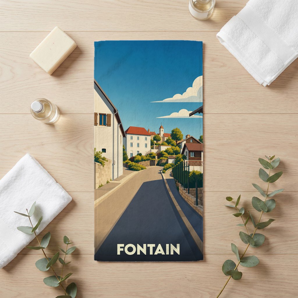 Serviette de bain souvenir de la ville de Fontain avec une illustration stylisée d'une rue pittoresque.