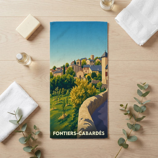 Serviette de bain souvenir de la ville de Fontiers-Cabardès avec une illustration stylisée d'un village médiéval.