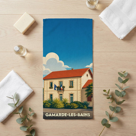 Serviette de bain souvenir de la ville de Gamarde-les-Bains avec une illustration stylisée.