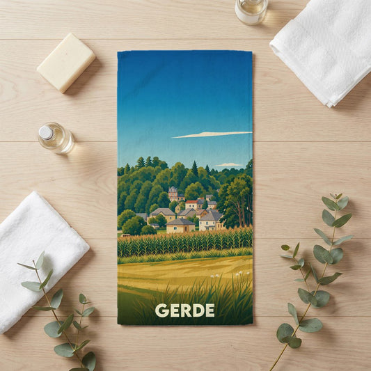 Serviette de bain souvenir de la ville de Gerde avec une illustration stylisée de paysages et de maisons.