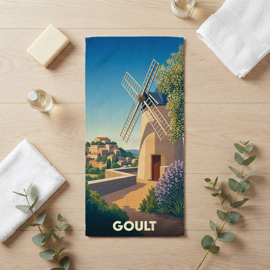 Serviette de bain souvenir de la ville de Goult avec une illustration stylisée d'un moulin provençal.