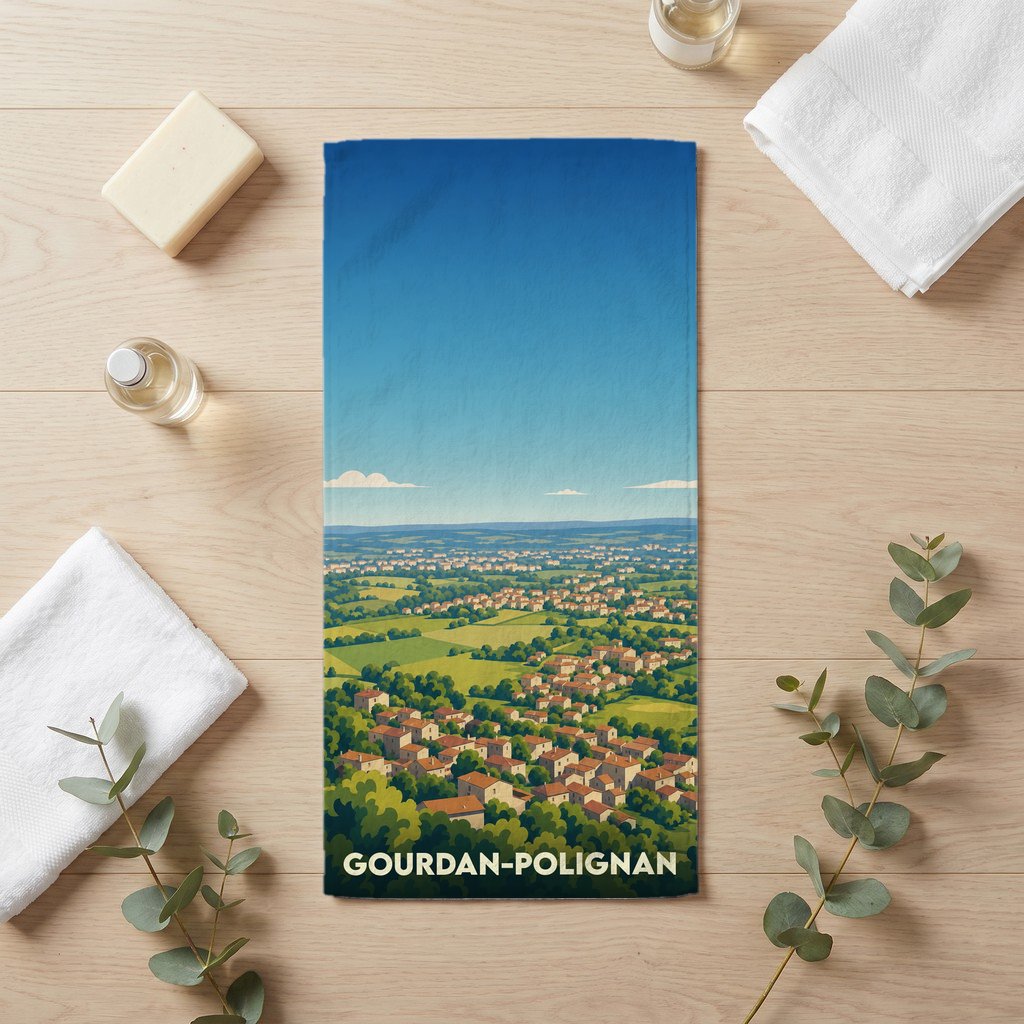 Serviette de bain souvenir de la ville de Gourdan-Polignan avec une illustration stylisée d'un paysage urbain.