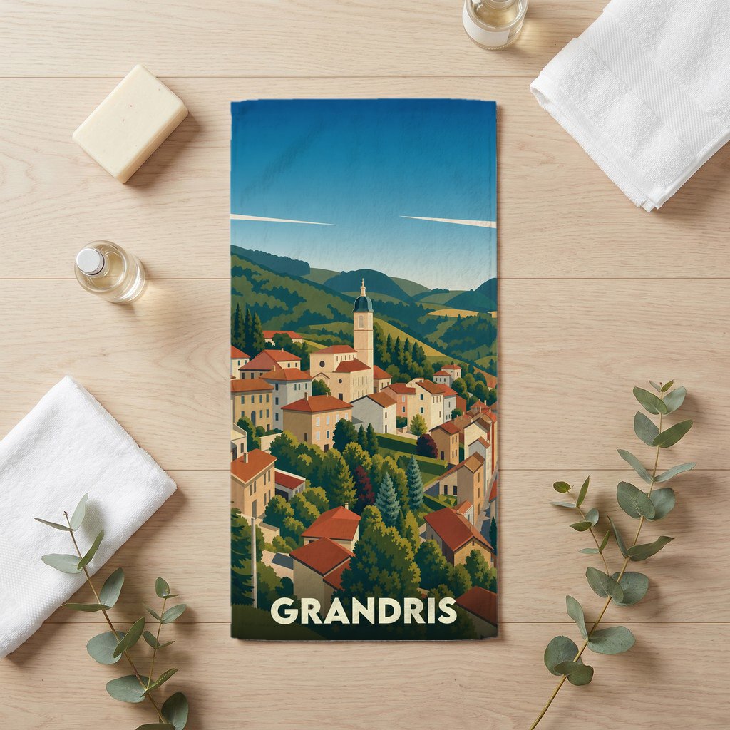 Serviette de bain souvenir de la ville de Grandris avec une illustration stylisée d'un village vallonné.