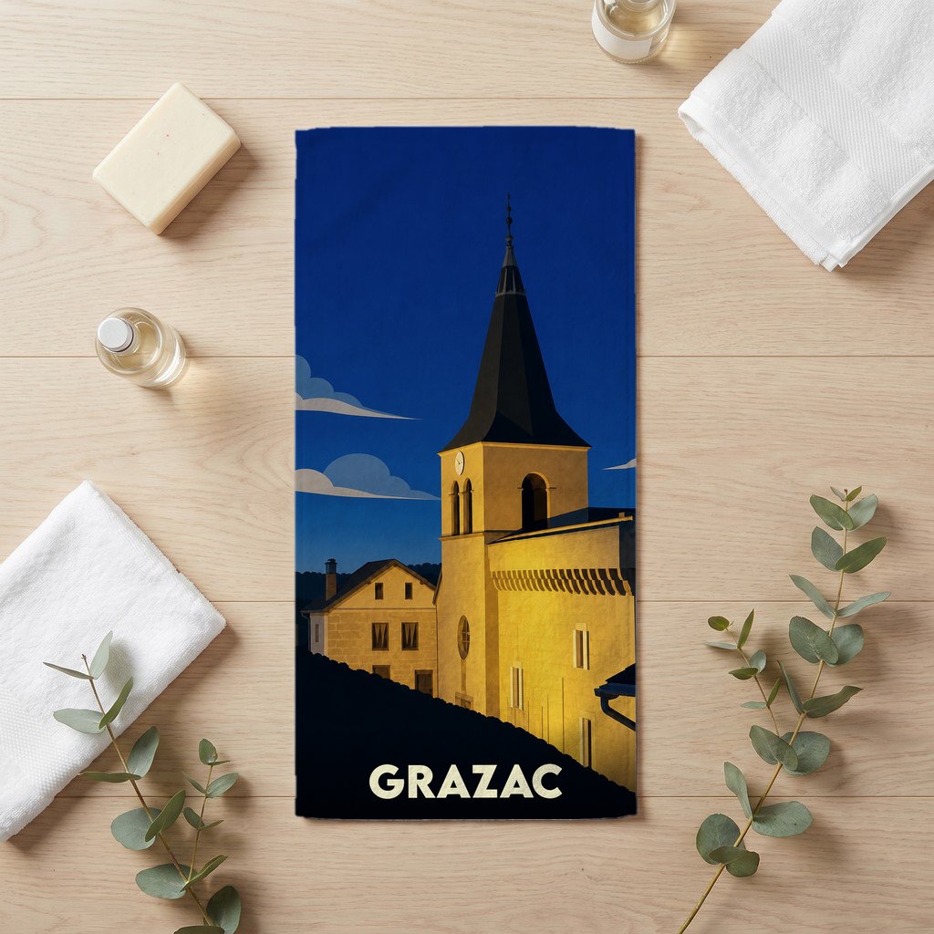 Serviette de bain souvenir de la ville de Grazac avec une illustration stylisée de son église au crépuscule.