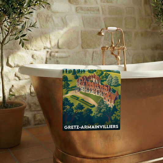 Serviette de bain souvenir de la ville de Gretz-Armainvilliers avec une illustration stylisée d'un château.