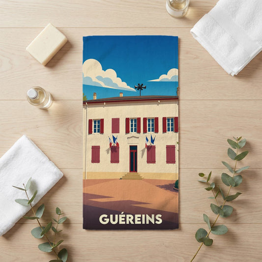 Serviette de bain souvenir de la ville de Guéreins avec une illustration stylisée.