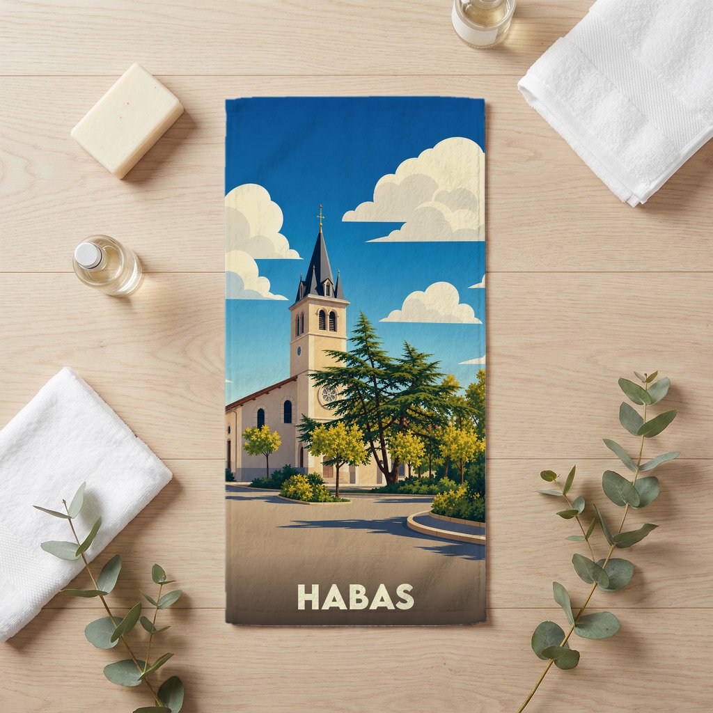 Serviette de bain souvenir de la ville de Habas avec une illustration stylisée d'une église sous un ciel nuageux.