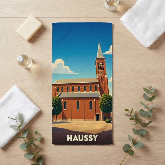 Serviette de bain souvenir de la ville de Haussy avec une illustration stylisée de son église.