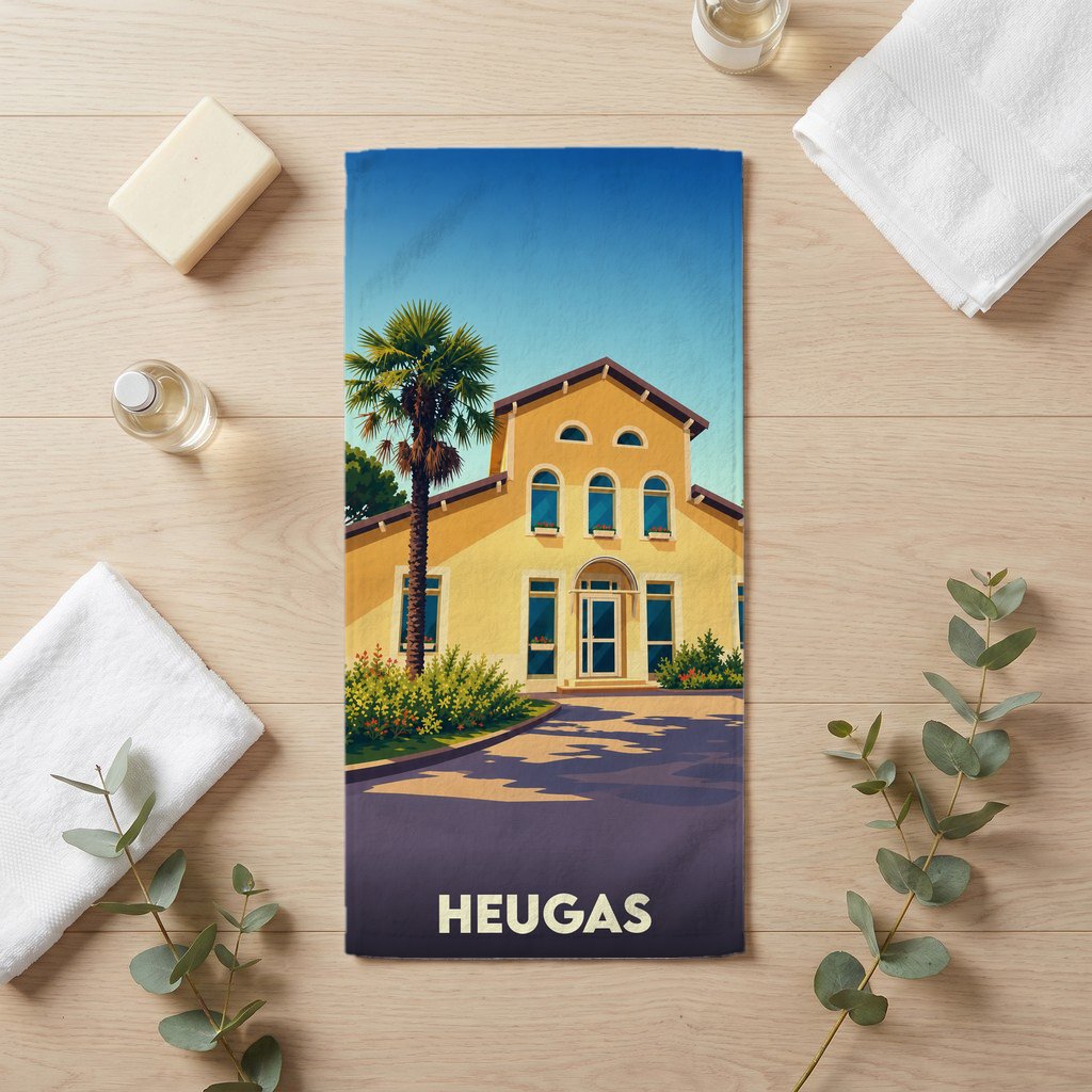 Serviette de bain souvenir de la ville de Heugas avec une illustration stylisée d'une maison landaise.