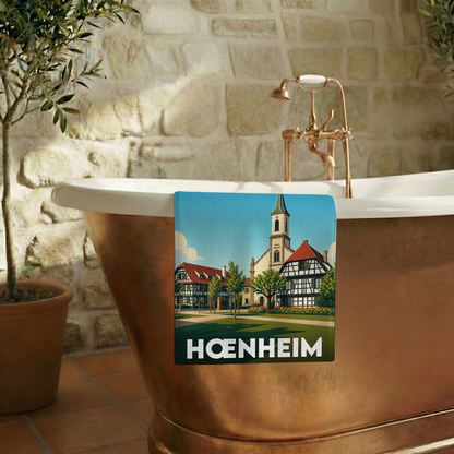 Serviette de bain souvenir de la ville de Hœnheim avec une illustration stylisée.