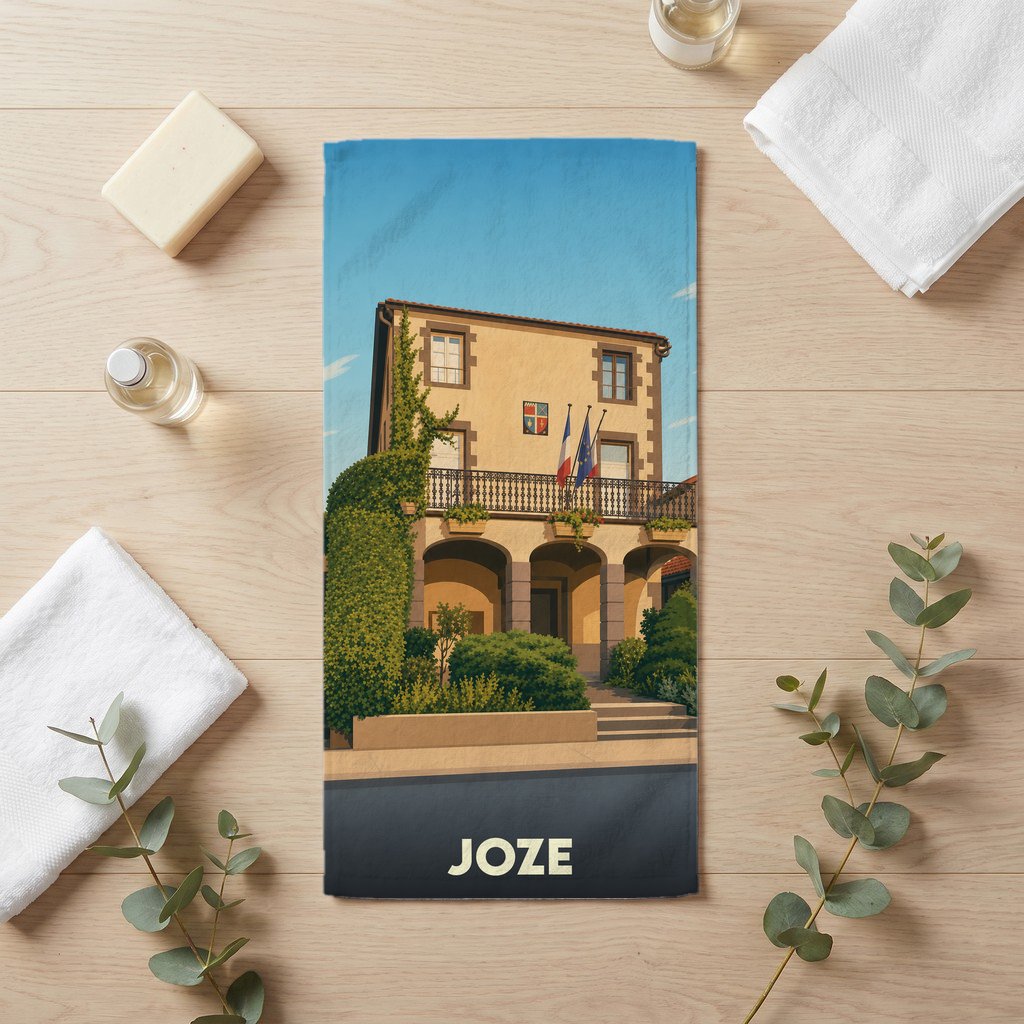 Serviette de bain souvenir de la ville de Joze avec une illustration stylisée d'un bâtiment provençal.