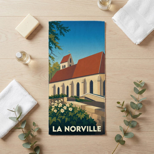 Serviette de bain souvenir de la ville de La Norville avec une illustration stylisée de son église.