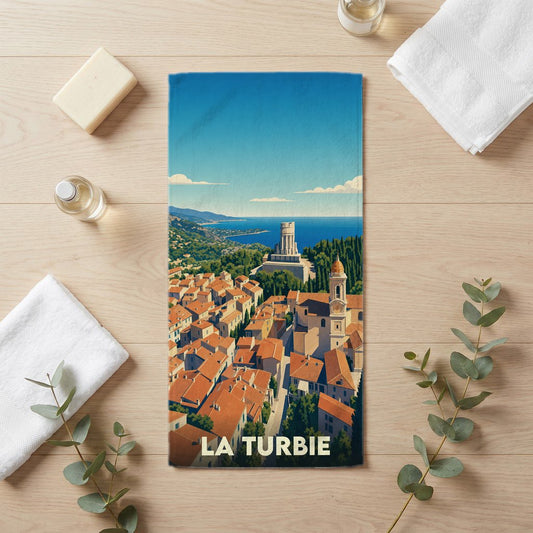 Serviette de bain souvenir de la ville de La Turbie avec une illustration stylisée.