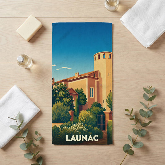 Serviette de bain souvenir de la ville de Launac avec une illustration stylisée.