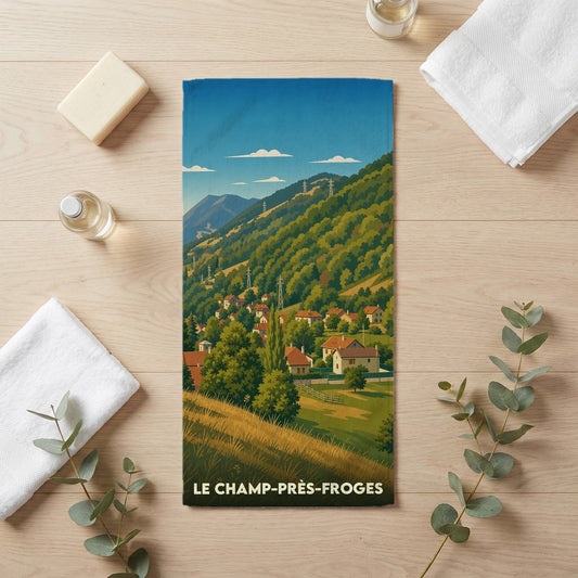 Serviette de bain souvenir de la ville du Champ-près-Froges avec une illustration stylisée de montagne.