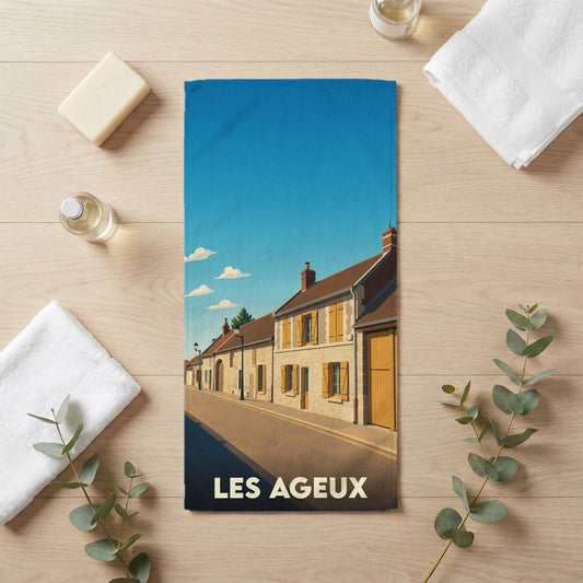 Serviette de bain souvenir de la ville de Les Ageux avec une illustration stylisée.