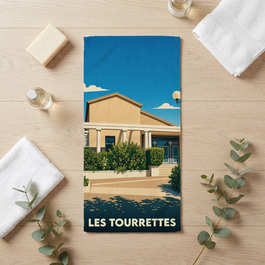 Serviette de bain souvenir de la ville de Les Tourrettes avec une illustration stylisée.