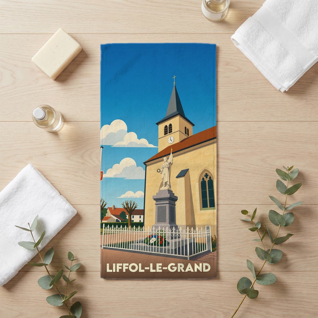 Serviette de bain souvenir de la ville de Liffol-le-Grand avec une illustration stylisée de son église et de son monument.