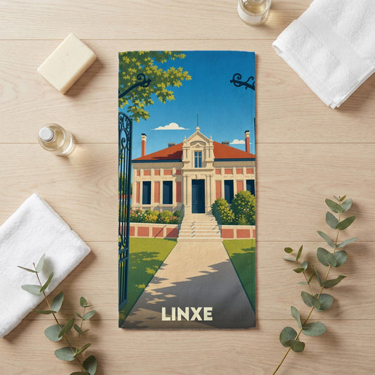 Serviette de bain souvenir de la ville de Linxe avec une illustration stylisée d'un manoir.