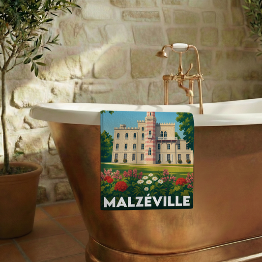 Serviette de bain souvenir de la ville de Malzéville avec une illustration stylisée de son château.