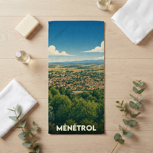 Serviette de bain souvenir de la ville de Ménétrol avec une illustration paysagère stylisée.
