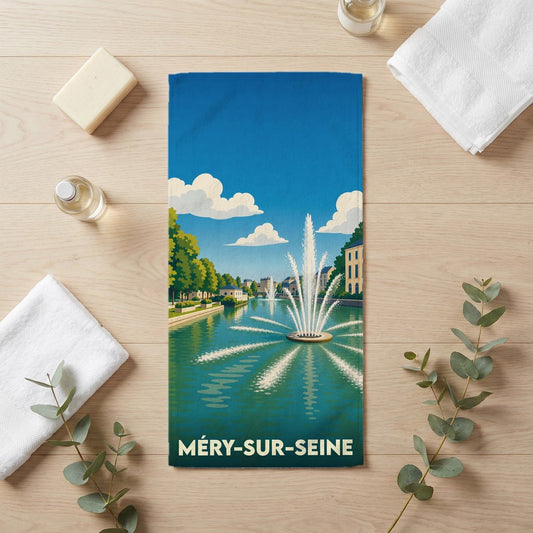 Serviette de bain souvenir de la ville de Méry-sur-Seine illustrée par une fontaine sur un cours d'eau.