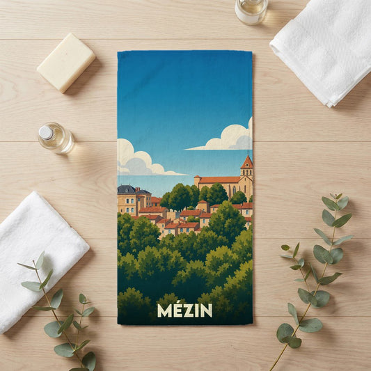 Serviette de bain souvenir de la ville de Mézin avec une illustration stylisée.