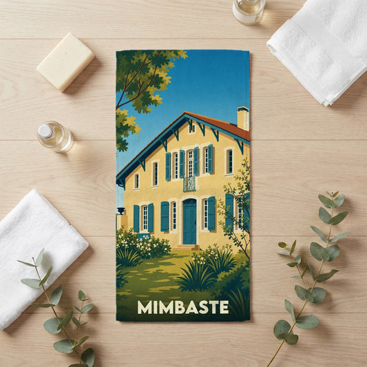 Serviette de bain souvenir de la ville de Mimbaste avec une illustration stylisée d'une maison landaise.